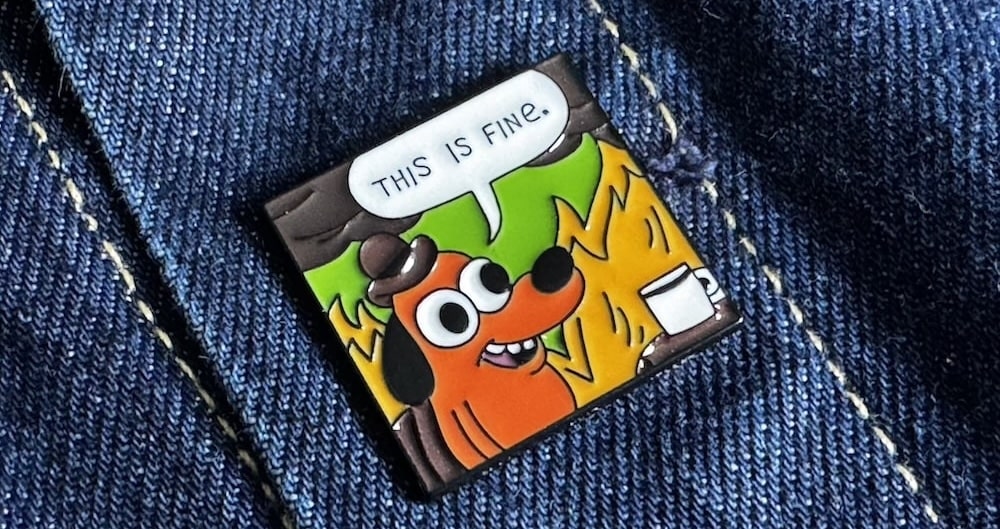 A “This is fine” meme on a pin badge