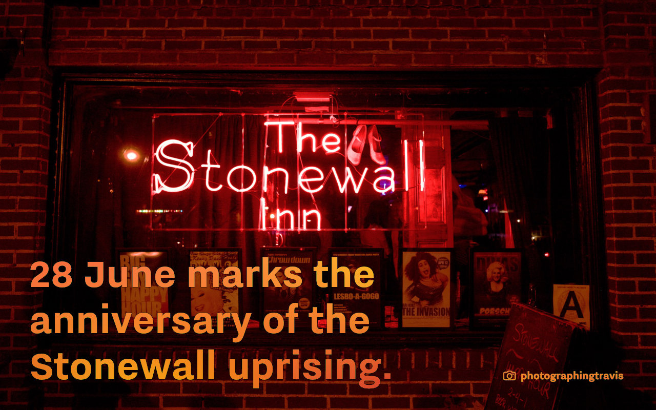 A screenshot of a slide with a photo of the Stonewall Inn in the background. Text: “28 June marks the anniversary of the Stonewall uprising.”
